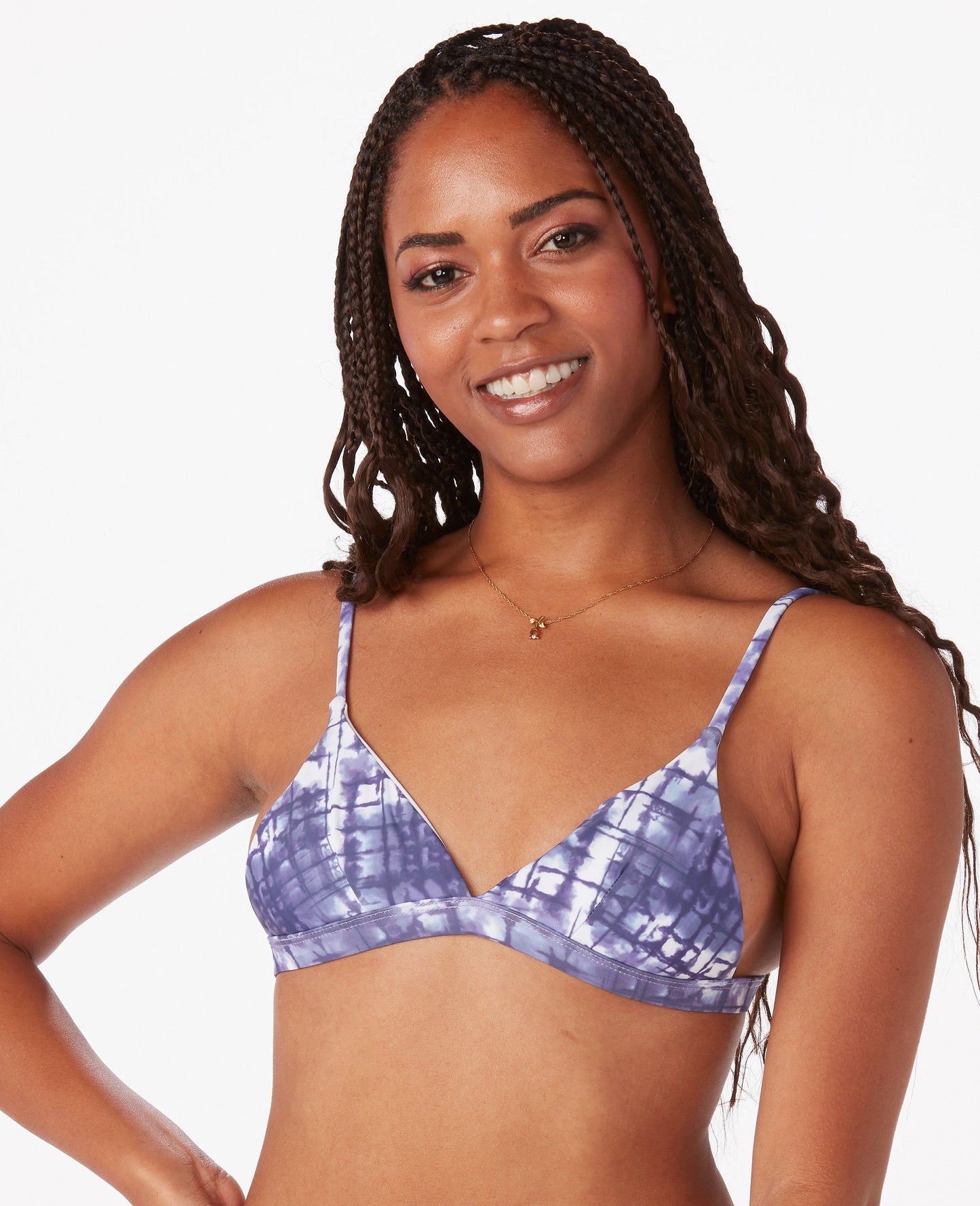 Woman in white and blue bikini against white background.