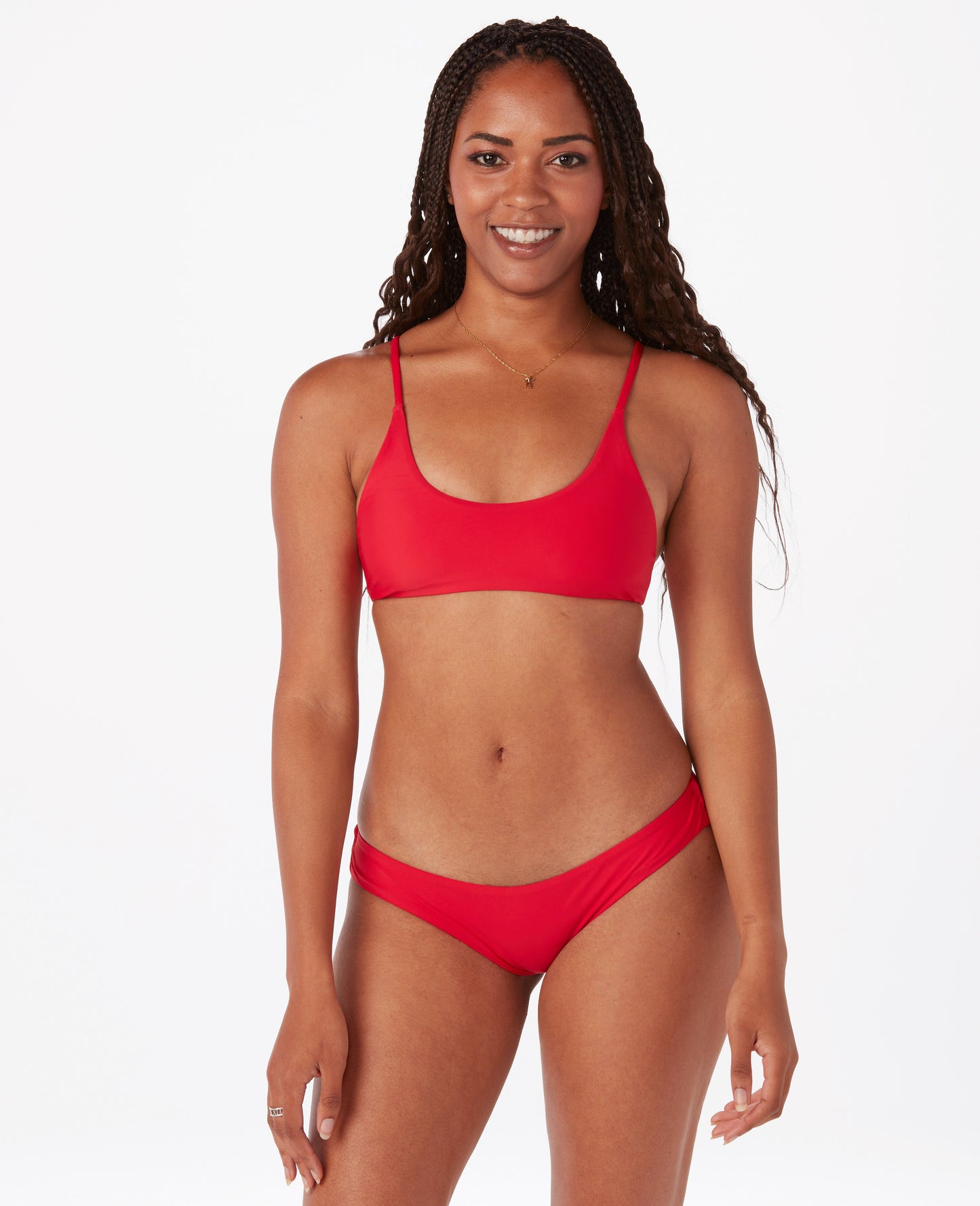 Woman in bright red bikini top against white background.