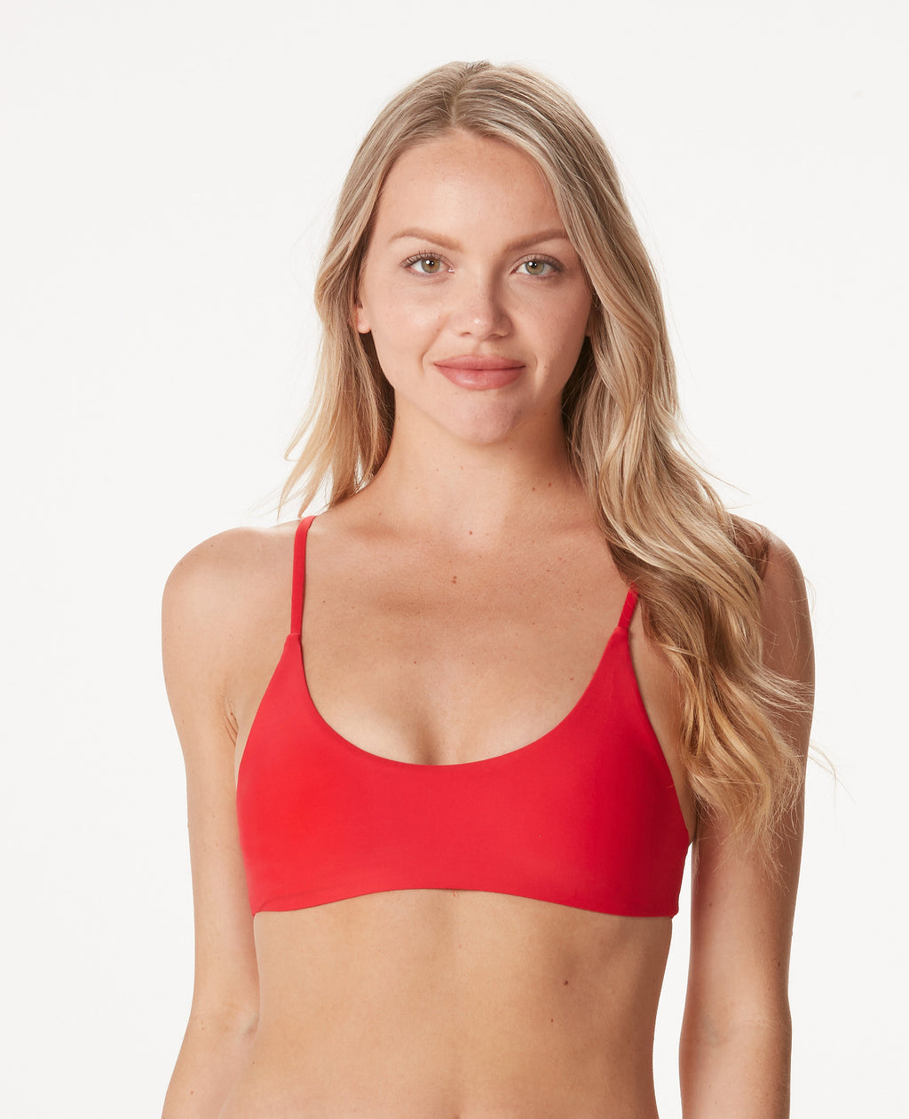 Woman in bright red bikini top against white background.